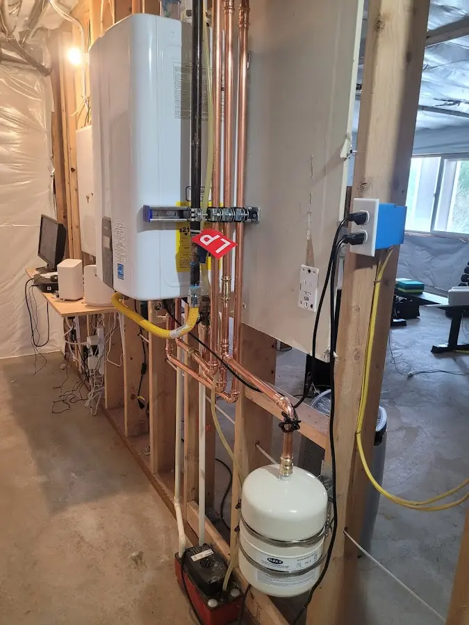 Licensed plumber repairing a kitchen sink in Clay